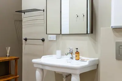 a bathroom with a white sink and a mirror at Renovated 1-Br Apartment Heart of Cannes in Cannes