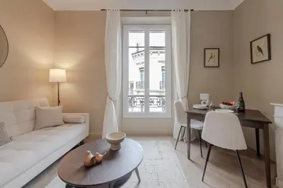 a living room with a white couch and a table at Renovated 1-Br Apartment Heart of Cannes in Cannes