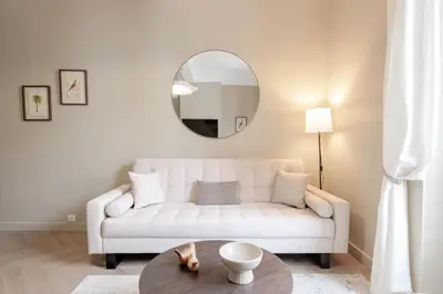 a living room with a white couch and a table at Renovated 1-Br Apartment Heart of Cannes in Cannes