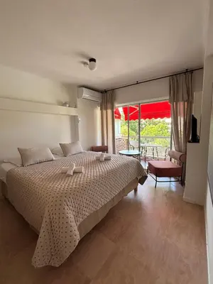 a bedroom with a bed and a large window at Studio au California Palace in Cannes