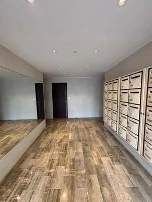 a large empty room with wood flooring and lockers at Studio au California Palace in Cannes