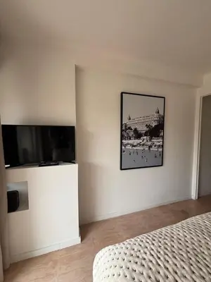 a bedroom with a bed and a flat screen tv at Studio au California Palace in Cannes
