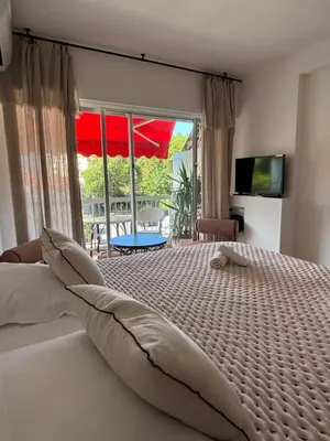a bedroom with a bed and a large window at Studio au California Palace in Cannes