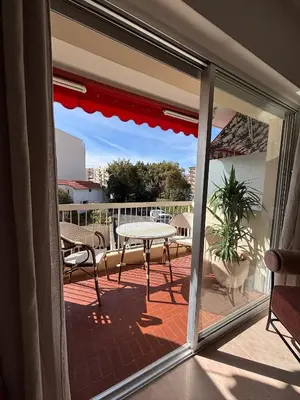 a view of a patio with a table and chairs at Studio au California Palace in Cannes