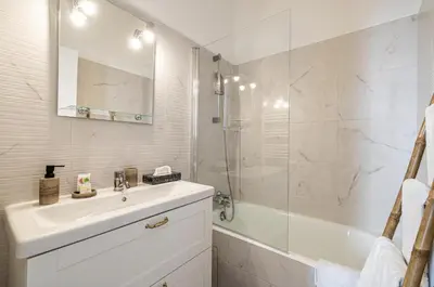 a white bathroom with a sink and a shower at 13 ANDRE1 - Hotel-Style Suite Studio 50m from Croisette in Cannes