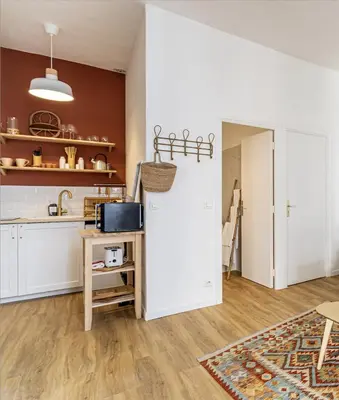 a kitchen with a white refrigerator and a table at 13 ANDRE1 - Hotel-Style Suite Studio 50m from Croisette in Cannes