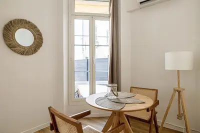 a dining room with a table and a window at 13 ANDRE1 - Hotel-Style Suite Studio 50m from Croisette in Cannes