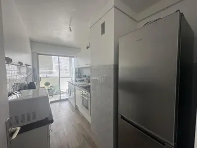 a kitchen with a stainless steel refrigerator and a window at Abou1895 in Cannes