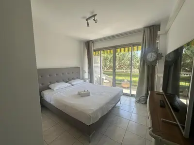 a bedroom with a bed and a clock on the wall at Abou1895 in Cannes
