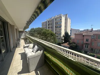 a balcony with white couches on a building at Abou1895 in Cannes