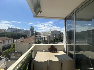 a balcony with a table and views of a city at Abou1895 in Cannes