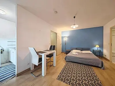 a bedroom with a bed and a desk and a table at Studio Etoile d'Or by Viva Riviera in Cannes