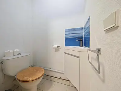 a bathroom with a toilet with a wooden seat at Studio Etoile d'Or by Viva Riviera in Cannes