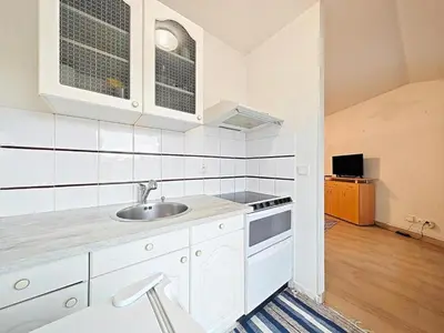 a white kitchen with a sink and a stove at Studio Etoile d'Or by Viva Riviera in Cannes