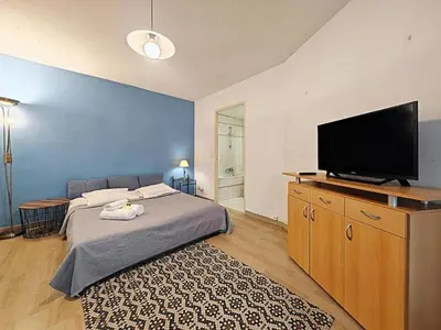 a bedroom with a bed and a flat screen tv at Studio Etoile d'Or by Viva Riviera in Cannes