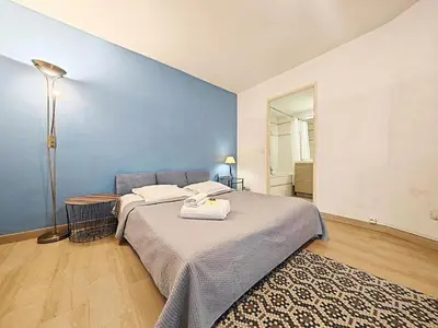 a bedroom with two beds and a blue wall at Studio Etoile d'Or by Viva Riviera in Cannes