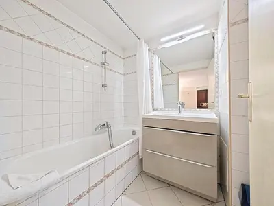 a white bathroom with a tub and a sink at Studio Etoile d'Or by Viva Riviera in Cannes