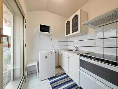 a white kitchen with a sink and a refrigerator at Studio Etoile d'Or by Viva Riviera in Cannes