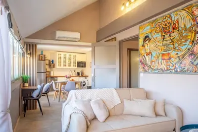 a living room with a couch and a kitchen at Apartment Cannes Felibriges in Cannes