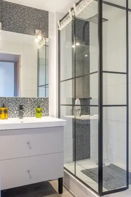 a glass shower in a bathroom with a white sink at Apartment Cannes Felibriges in Cannes