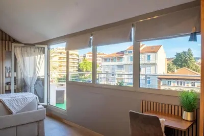 a living room with a window with a view of a building at Apartment Cannes Felibriges in Cannes