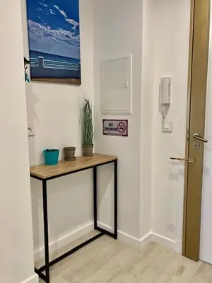 a hallway with a table with a plant on it at Résidence Cannes in Cannes