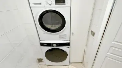 a washer and dryer sitting in a bathroom at Luxurious 3-Bedroom Apartment in Heart of Cannes in Cannes