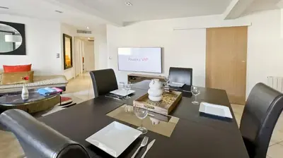 a living room with a large black table and chairs at Luxurious 3-Bedroom Apartment in Heart of Cannes in Cannes