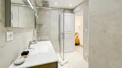 a bathroom with a shower and a white sink at Luxurious 3-Bedroom Apartment in Heart of Cannes in Cannes