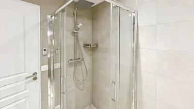 a shower with a glass door in a bathroom at Luxurious 3-Bedroom Apartment in Heart of Cannes in Cannes