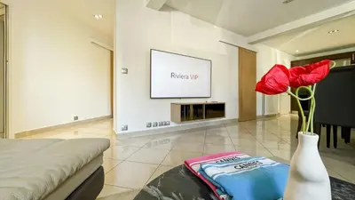 a room with a vase with red roses in it at Luxurious 3-Bedroom Apartment in Heart of Cannes in Cannes