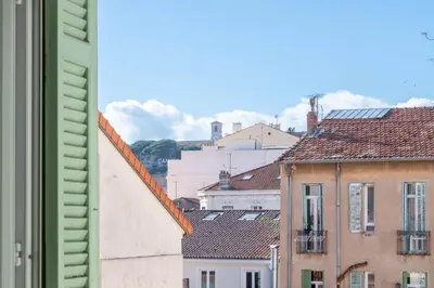 a view from a window of roofs of buildings at Modern 2-Br Apartment with Balconies 3 Min from Palais des Festivals in Cannes