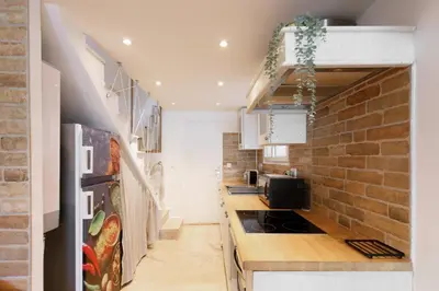 a kitchen with a counter and a brick wall at Immogroom - Maisonnette - T3 - A/C - Wifi in Cannes