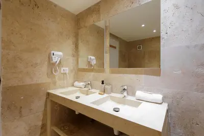 a bathroom with a sink and a mirror at Immogroom - Maisonnette - T3 - A/C - Wifi in Cannes