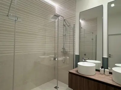a bathroom with two sinks and a glass shower at Appartement Centre Cannes in Cannes