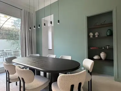 a dining room with a black table and chairs at Appartement Centre Cannes in Cannes