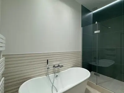 a bathroom with a tub and a glass shower at Appartement Centre Cannes in Cannes
