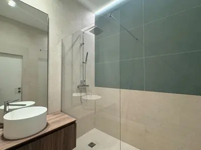a bathroom with a sink and a glass shower at Appartement Centre Cannes in Cannes