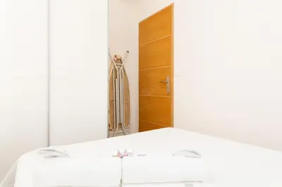 a bedroom with a bed with a mirror and a closet at Le Cosy YourHostHelper in Cannes