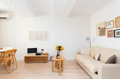 a living room with a couch and a table at Le Cosy YourHostHelper in Cannes