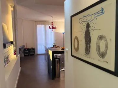 a living room with a painting of a cat on the wall at 
