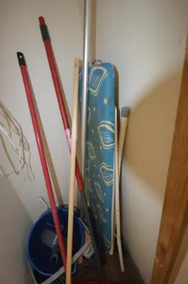 a group of baseball bats and a blue snowboard at 
