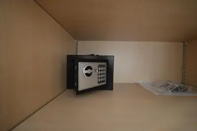 a microwave sitting in a corner of a room at 