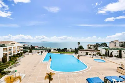 an image of a swimming pool with the ocean in the background at Résidence Cannes Villa Francia - maeva Home - Appartement 2 pièces 4 personnes - Sélection MAE-5131 in Cannes