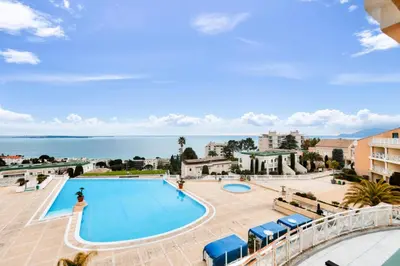 a view of a swimming pool with the ocean in the background at Résidence Cannes Villa Francia - maeva Home - Appartement 2 pièces 4 personnes - Sélection MAE-5131 in Cannes