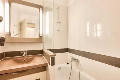a bathroom with a sink and a mirror and a tub at Résidence Cannes Villa Francia - maeva Home - Appartement 2 pièces 4 personnes - Sélection MAE-5131 in Cannes