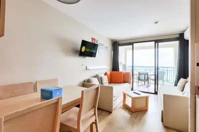 a living room with a table and a dining room at Résidence Cannes Villa Francia - maeva Home - Appartement 2 pièces 4 personnes - Sélection MAE-5131 in Cannes