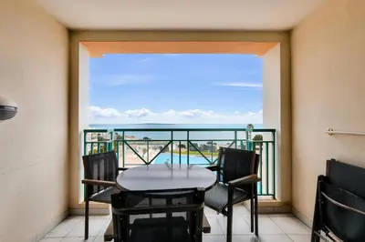a balcony with a table and chairs and a view of the ocean at Résidence Cannes Villa Francia - maeva Home - Appartement 2 pièces 4 personnes - Sélection MAE-5131 in Cannes