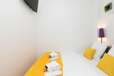 a room with a bed with towels and pillows at Pelige 5 YourHostHelper in Cannes
