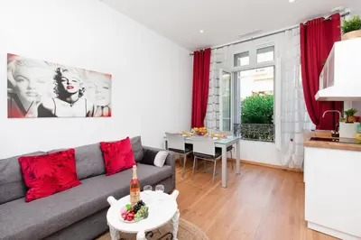 a living room with a couch and a table at Pelige 5 YourHostHelper in Cannes